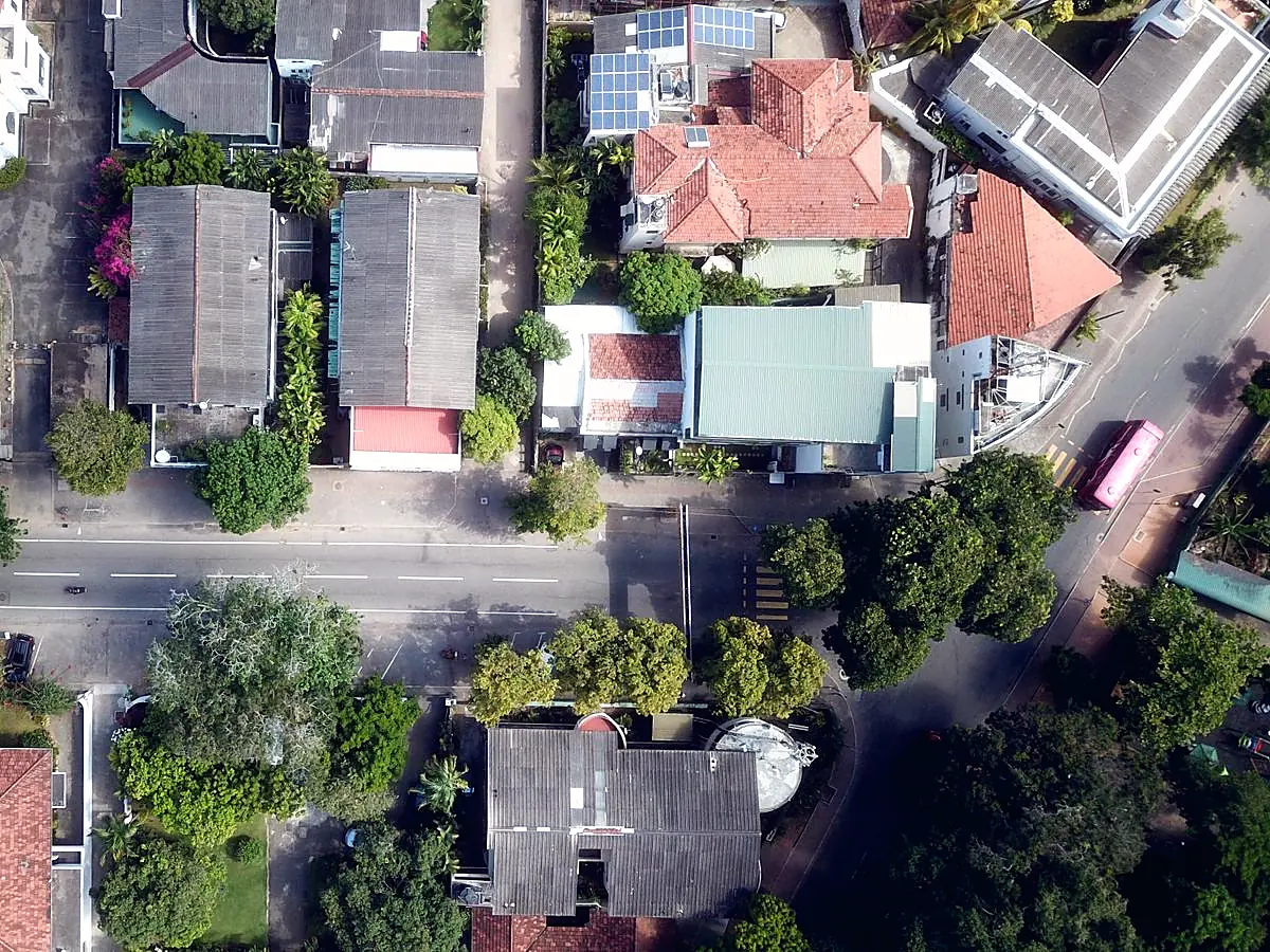 Aerial view of homes and rooftops in Colombo, Sri Lanka, one with solar panels