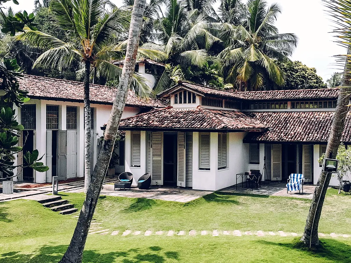 Tile-roofed Sri Lankan home among coconut palms
